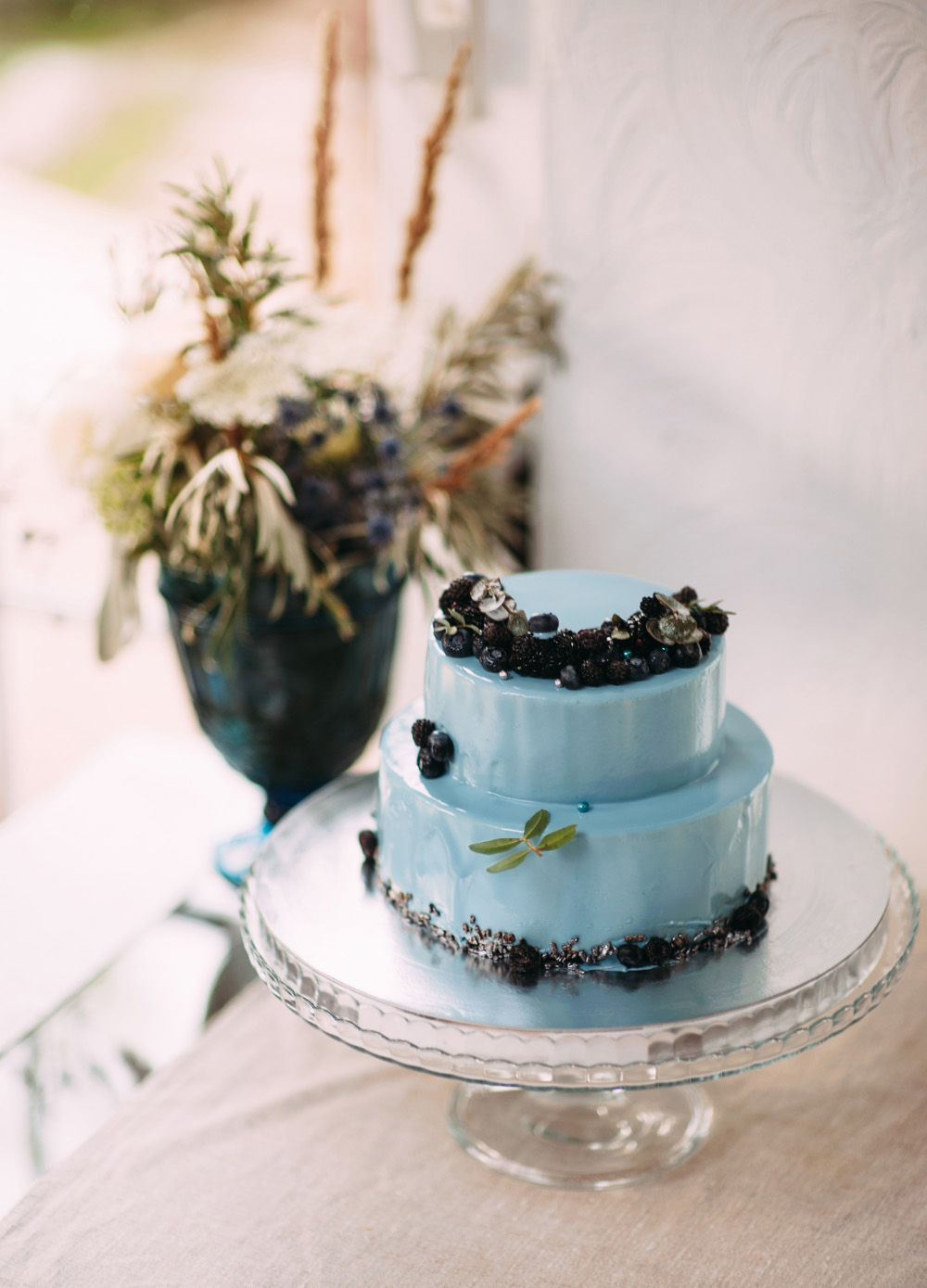 Romantic Blue Lakeside Wedding inspiration - Blue wedding cake by centerpiece